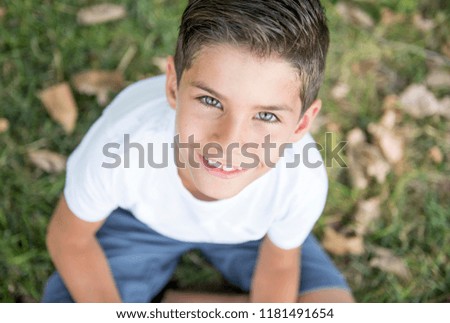 Handsome child with lovely eyes posing in the park