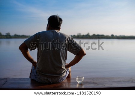 Man sitting near the river