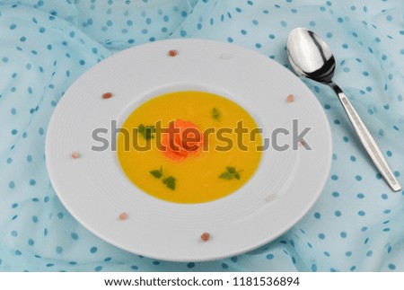 Cream soup carrots, which is decorated with parsley. A light appetizer for lunch or dinner.