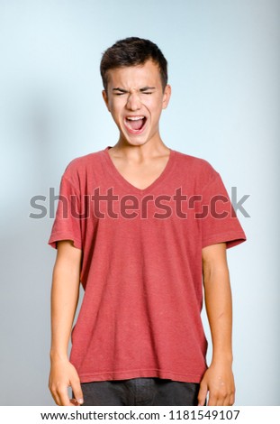 young man screaming, isolated studio photo on background