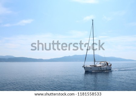 Sailing in the Ionian Sea - sailing boats (catamara and monohull) travelling in the wide open. Sunset and mid-day views. Royalty-Free Stock Photo #1181558533