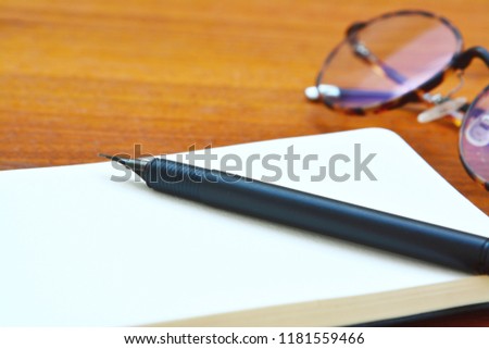 My skecthing book with fountain pen and glasses on my wooden table