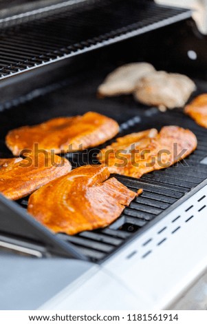 Grilling cod for fish tacos on outdoor gas grill.