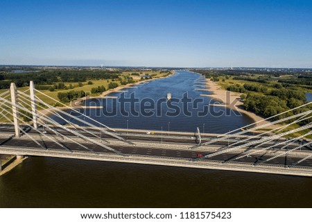 Aerial view of the bridge and the road with cars over the river Rhine in an area of the Netherlands