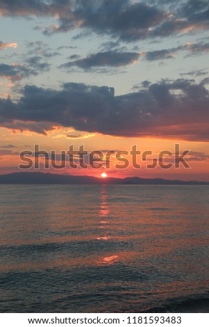 Amazing sunrise at Mediterranean sea in Greece. Colorful view at early summer morning sun.