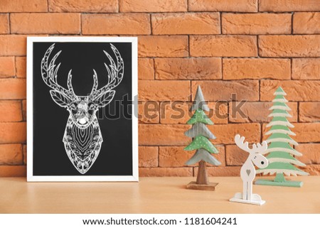 Christmas decorations on table near brick wall
