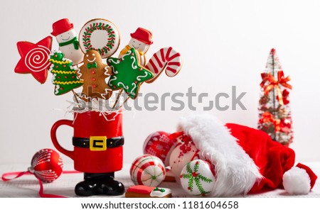 Set of Christmas gingerbread on sticks in a red gift cup. Christmas concept with copy space.