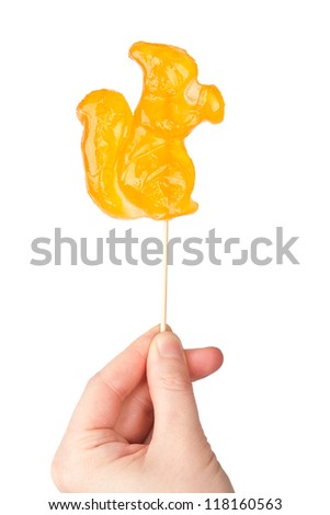 Hand holding squirrel shape lollipop isolated on white background