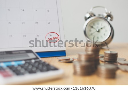 Tax payment season and finance debt collection deadline concept. Money coins stack, calendar, calculator and clock Royalty-Free Stock Photo #1181616370