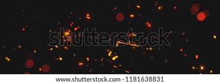 blurred sparks from fire in front of black backgound Royalty-Free Stock Photo #1181638831