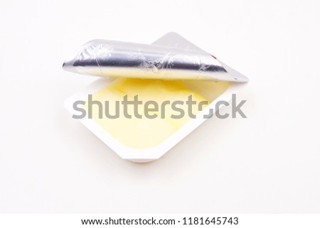Small single serve pack of butter 
 Royalty-Free Stock Photo #1181645743