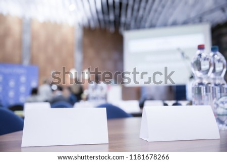 White Name Tag on Office Desk at Public Meeting Royalty-Free Stock Photo #1181678266