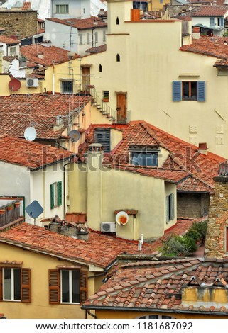 Top view. Many yellow buildings with red tile roofs in the old city. Urban landscape. West Europe.