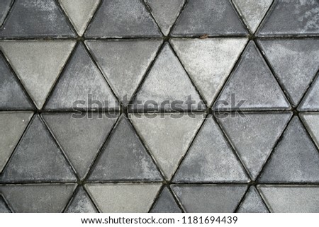 Abstract scene of Dark gray Concrete block triangular or cement block on the ground foot floor surface texture background                         