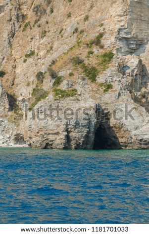 Background for design, texture of steep cliffs and blue sea water