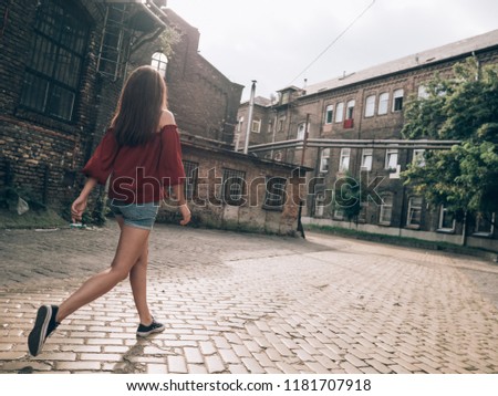 Woman walking at abandoned city