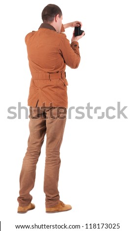 Back view of man photographing.   stylishly dressed in casual clothes photographer. Rear view people collection.  backside view of person.  Isolated over white background.