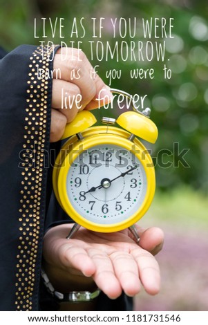 Inspiration Motivational words LIVE AS IF YOU WERE TO DIE TOMORROW. LEARN AS IF YOU WERE TO LIVE FOREVER with background of the clock
