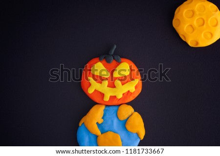Happy Halloween. Childlike Halloween Art. The Moon, Earth and Pumpkin are made out of modeling clay.