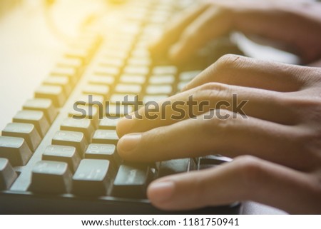 Businessman working close up hand on keyboard  with sunlight.