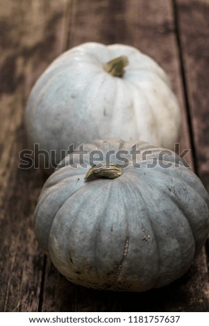 Gray and green pumpkins for Halloween on a wooden background