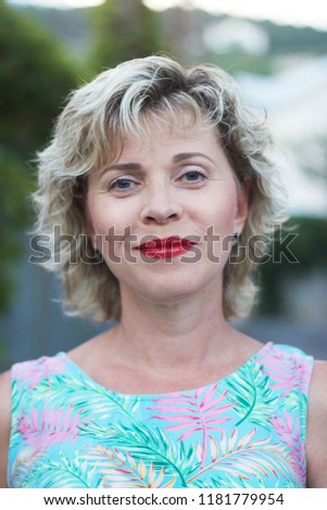 A lovely, curly-haired middle-aged woman Royalty-Free Stock Photo #1181779954