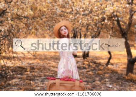 search bar on the background blurred photo of girl with leather suitcase for travel
