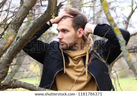 Young beard man in a autumn park