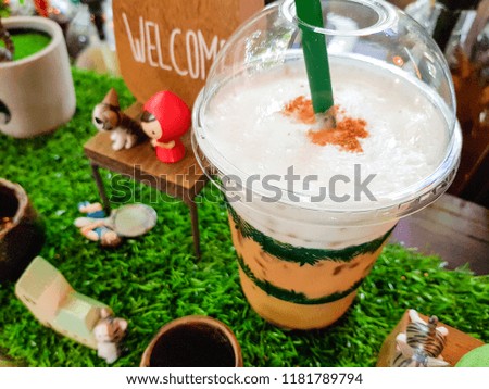 cool cappuccino and wooden dolls on grass, Welcome drinks.