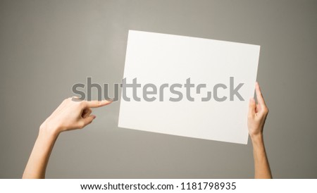 woman holding a sheet of paper in her hand
