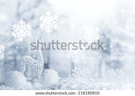 Deer and Christmas ball in snowfall,Christmas background.