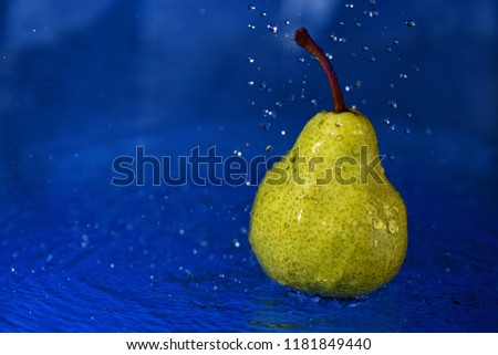 green pear in water with drops