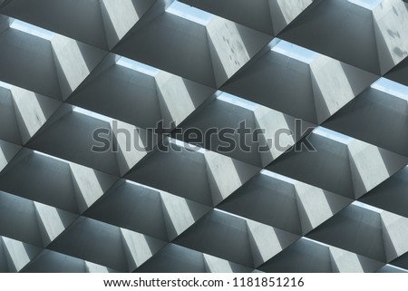 Brutalist architectue style concrete and glass  skylight roof beams arranged diagonally letting in light to public space Royalty-Free Stock Photo #1181851216