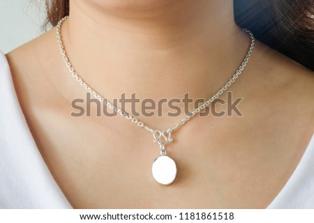 Woman wearing a mockup montage necklace with empty for add your advertising. Royalty-Free Stock Photo #1181861518