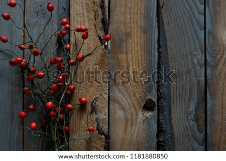 Hawthorn berries on the wooden background. Autumn background. Top view