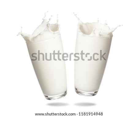 Couple milk splashing out of glass isolated on white background. Royalty-Free Stock Photo #1181914948