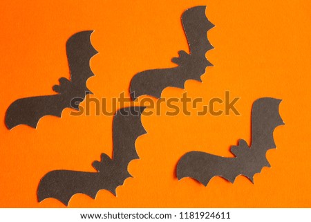 bats made of paper on orange background