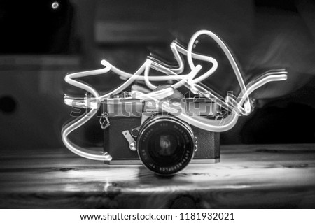 an analog camera on the table with lights around it
