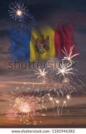 Holiday sky with fireworks and flag of Moldova, independence day