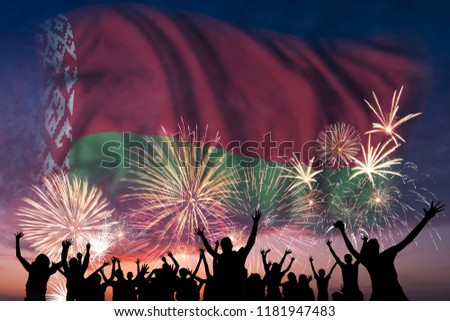 Happy people are looking holiday fireworks with flag of Belarus in sky, independence day