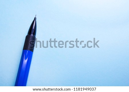 
Work space with an empty clip. Accessories that lie on the table. Work space on a blue background.