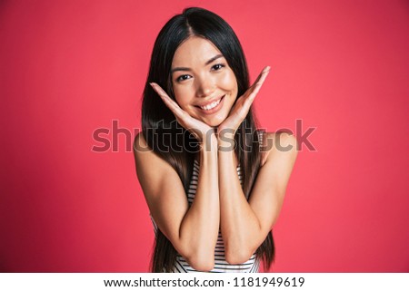 Happy and excited beautiful young asian woman portrait isolated on pink background. People emotions concept
