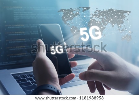 5G High speed internet network communication, man using mobile smartphone with 5G icons flow on virtual screen, worldwide connection. Internet of Things, IoT concept Royalty-Free Stock Photo #1181988958