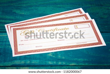 Blank Gift Voucher on a Blue Wooden Table
