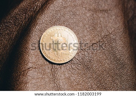 bitcoin on leather. the concept of crypto currency in the production of clothes made of leather and other materials.