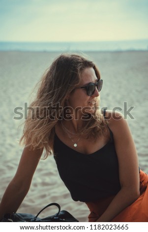 Beautiful curly blonde hair girl wearing sunglasses