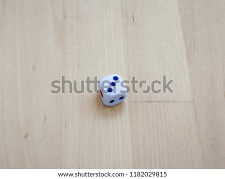 White dice isolated on wooden background