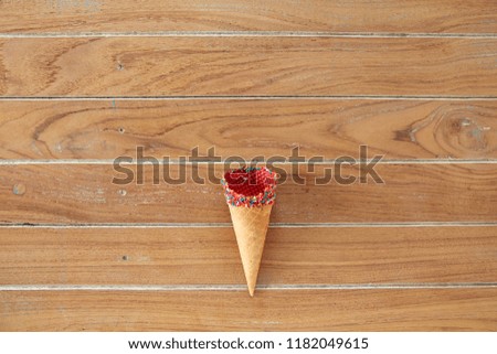 Flat-lay of waffle sweet cone on wooden Turquoise background. Sweet, summer and empty concept. Top view
