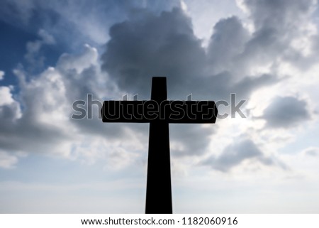 Wooden cross and sky with clouds background.