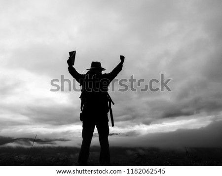  travel man with backpack raised hands on the mountain. success concept.